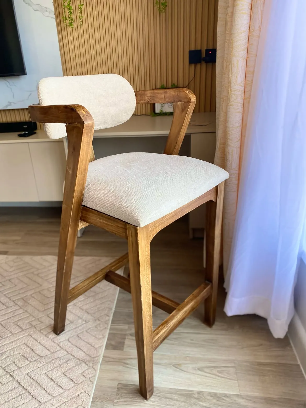Branton wooden bar stool with cream padded seat and backrest