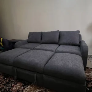 Dark grey sofa bed opened flat into a 5x6 bed with spring cushions and three back cushions