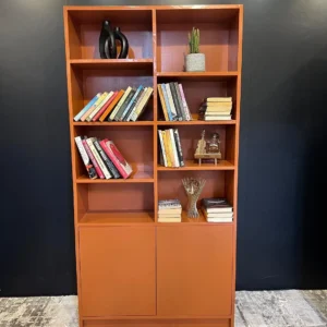 Parkborough rust orange bookshelf with open shelves and lower cabinet