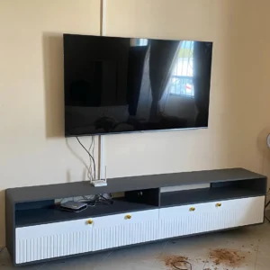 Two-tone TV cabinet with white fluted doors and open shelving