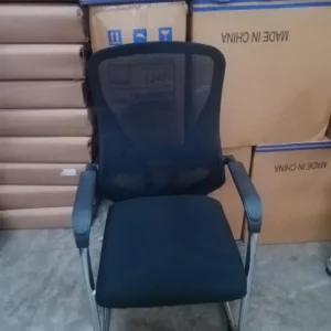 Black mesh visitor office chair with padded seat and fixed armrests