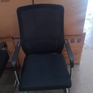 Black full-mesh visitor office chair with fixed armrests