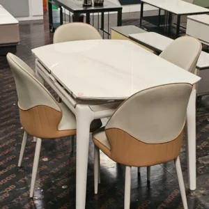 Modern white dining table with glossy stone-look top and dining chairs
