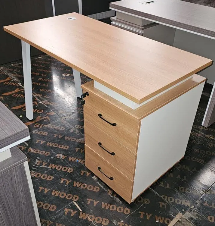Compact light wood-look office desk with three-drawer pedestal