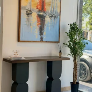 Black sculptural console table with geometric pedestal supports in Kenya
