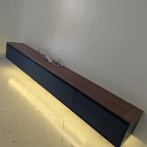 Black and warm-brown low TV stand with closed front storage