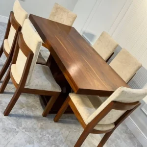 Brown 6 seater dining table with angled pedestal base and upholstered chairs