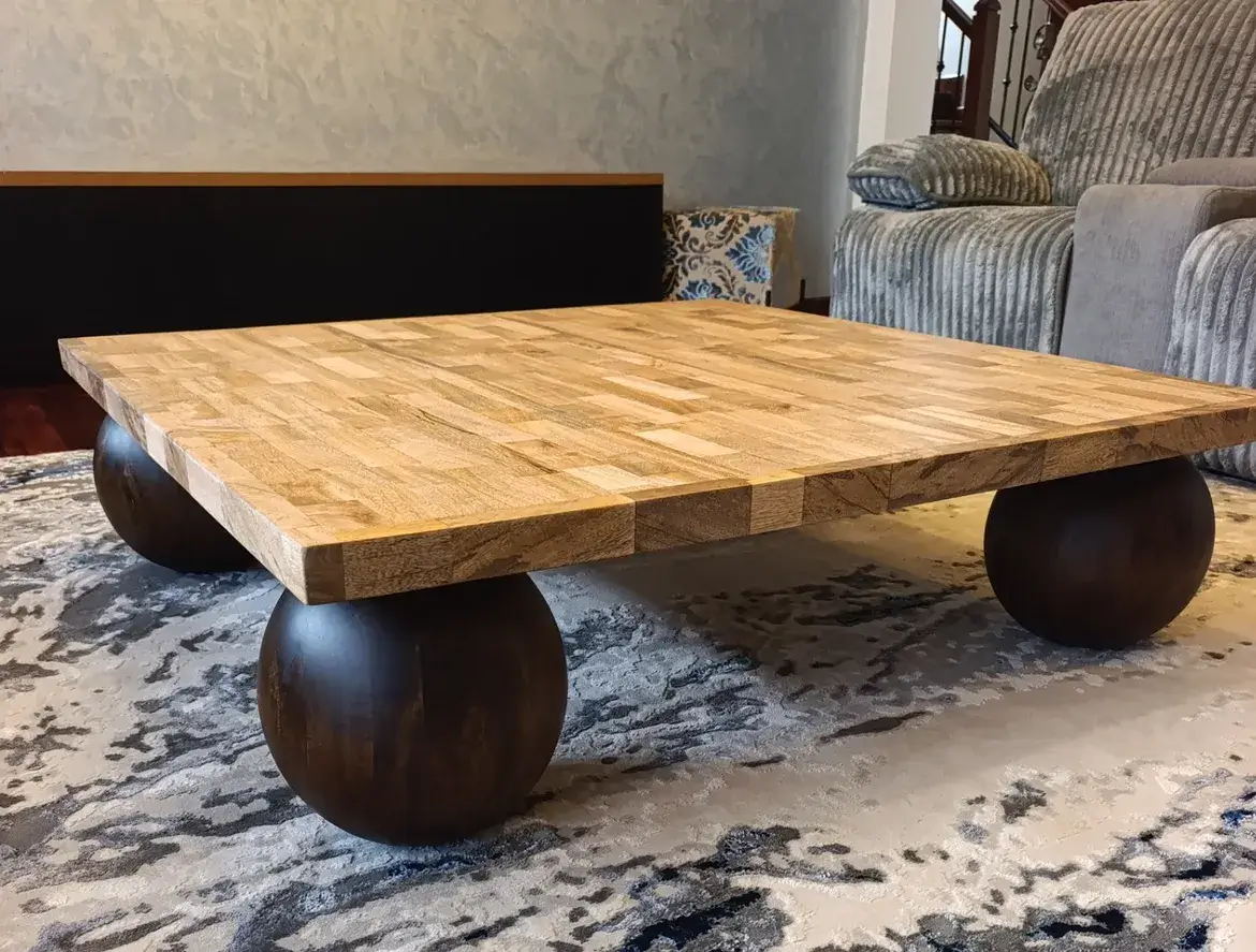 Brown square mahogany coffee table with patterned top and rounded legs