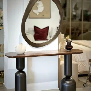 Brown-top sculptural console table with black pedestal supports in Kenya