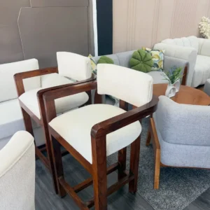 Cream padded bar stool with warm brown open frame and footrest