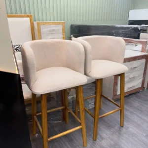 Cream padded bar stool with curved wraparound back and brown frame