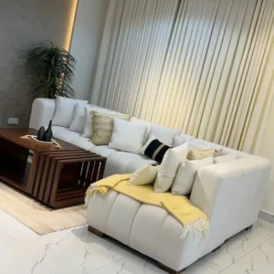 Cream corner sectional sofa with broad seats and loose back cushions