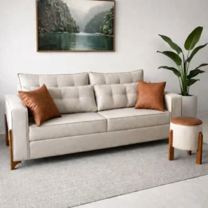 Cream sofa with layered tufted back cushions and warm wood-tone side accents