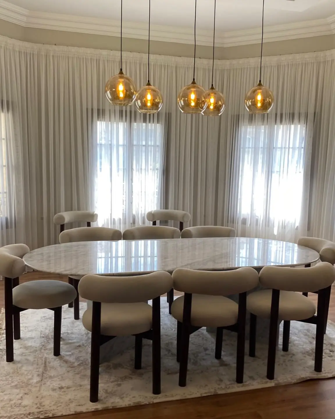 8 seater cream marble dining table with padded cream chairs