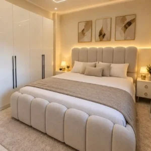 Cream upholstered bed with seven-panel rounded headboard and matching footboard