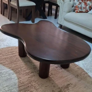 Dark brown freeform coffee table with rounded sculptural tabletop