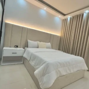 5×6 fabric bed with wide vertical-panel upholstered headboard