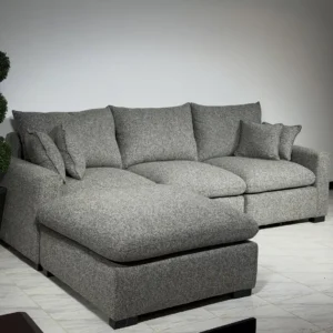 Grey corner couch for living room with broad chaise and loose cushions