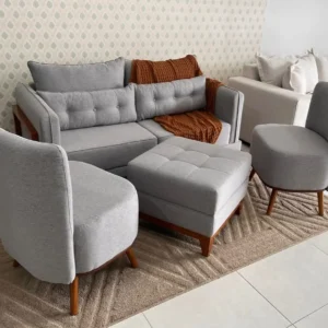 Grey sofa and chair set with two rounded lounge chairs and matching square ottoman
