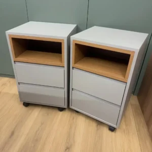 Grey two-drawer mobile office pedestal with open cubby and caster wheels