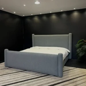 Grey upholstered 5×6 bed with tall padded headboard, matching footboard and rounded corner posts