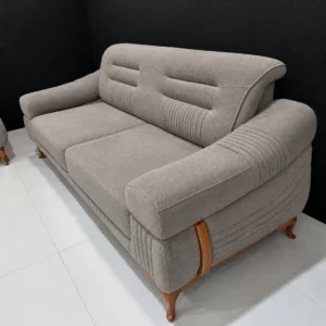 Light grey 5 seater sofa with ribbed arms and wood-tone accents in Kenya