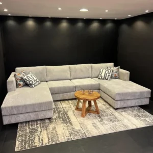 Light grey ribbed U-shape sectional sofa with two extended lounging ends in a modern living room
