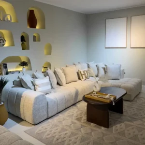 Light neutral sectional sofa with channel-tufted seats and chaise