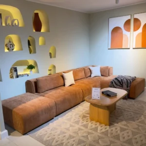 Low-profile brown L-shaped sofa with chaise and loose back cushions