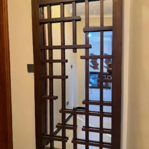 Mahogany engraved wall mirror with geometric wood overlay