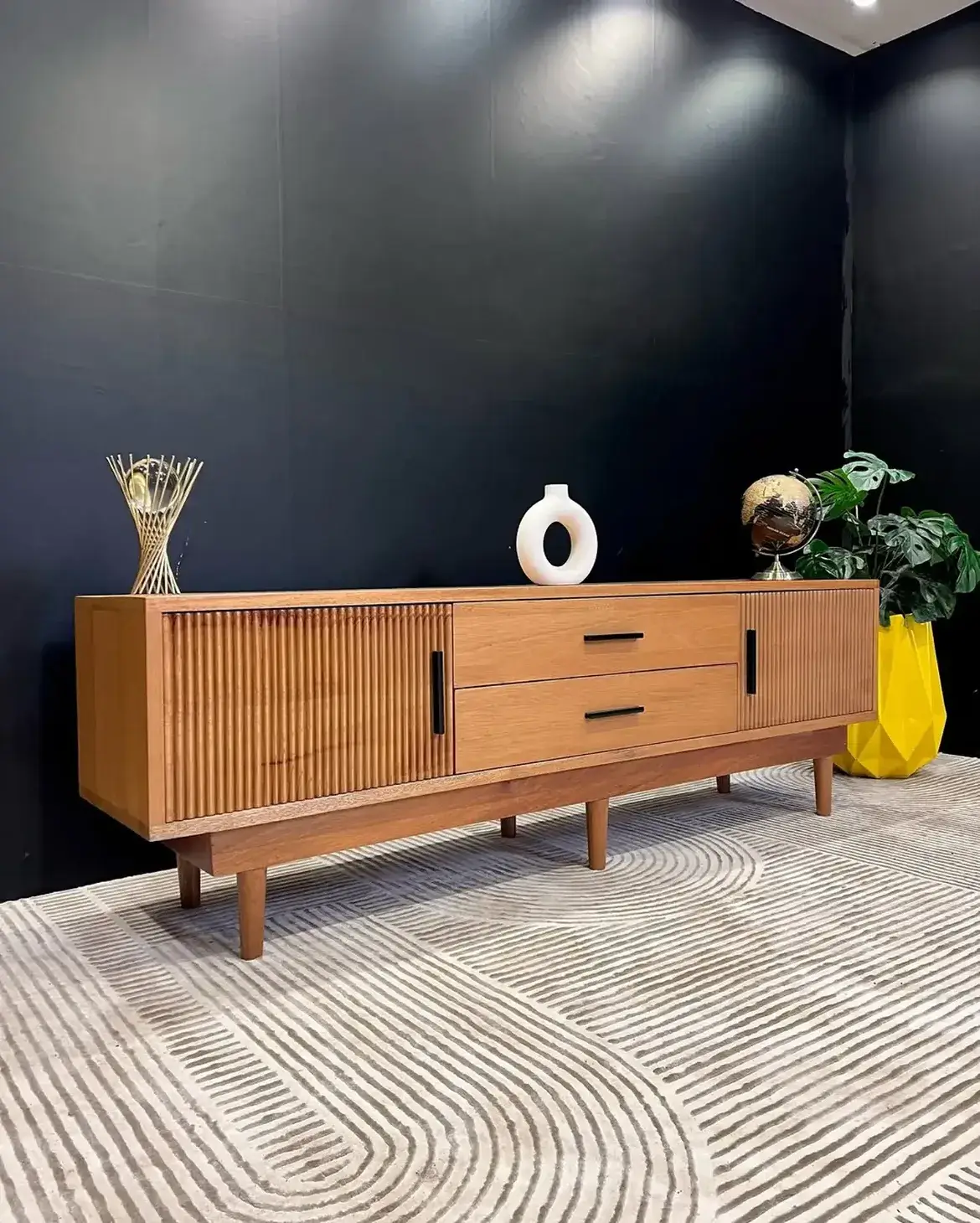 Meru Oak 6ft TV console with ribbed cabinet fronts, two central drawers, dark handles and raised legs