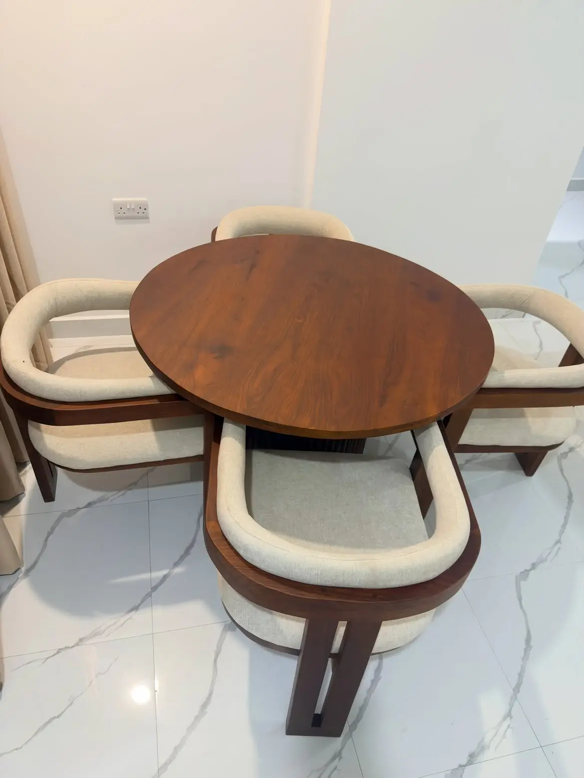 Mninga 4 seater dining set with brown rounded table and four cream upholstered armchairs in Kenya