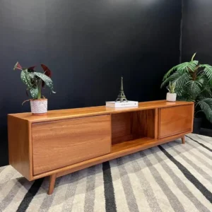 Modern wooden TV cabinet in warm brown with two closed storage sections, central open compartment and tapered legs