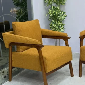 Mustard upholstered accent chair with open brown frame and padded arms