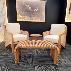 Natural slatted rectangular centre table with curved legs between two cream upholstered lounge chairs