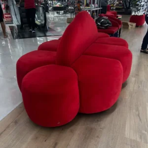 Red sculptural business lounge chair with rounded upholstered sides and tall backrest