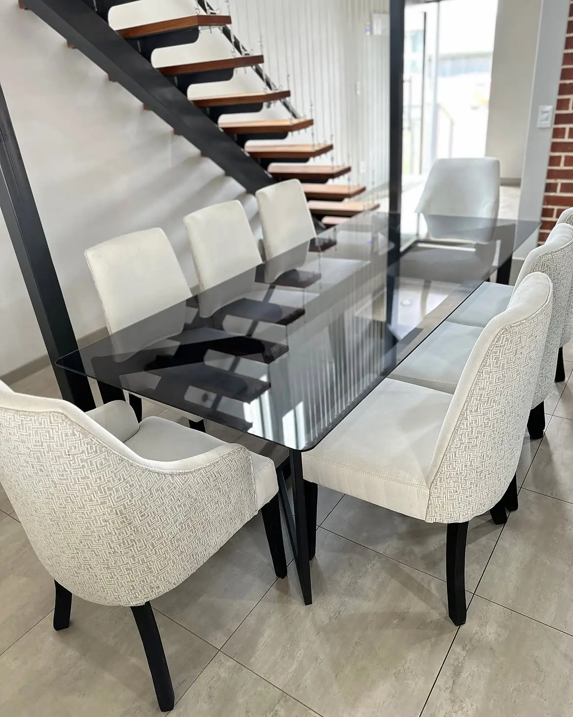 8 seater tempered glass dining set with light upholstered chairs in Kenya