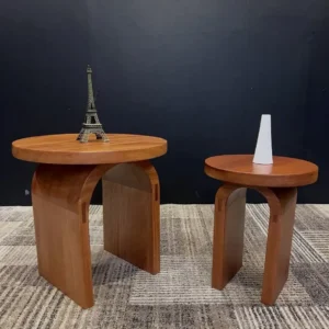 Two warm walnut-tone round nesting coffee tables with curved panel bases