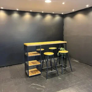 Wood-look breakfast bar set with black frame, open side shelves and three matching round stools