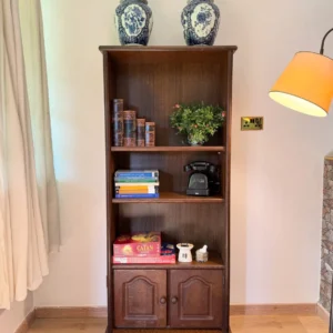 Dark-brown antique-style wooden bookshelf with three open compartments and two lower cabinet doors