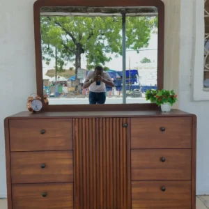 Monsoon Adelphi mahogany dressing table with large rectangular mirror, six drawers, fluted centre panel and dark round knobs.
