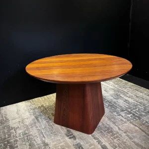 Monsoon Alderleigh oval mahogany coffee table with warm brown wood-grain top and tapered central pedestal base.