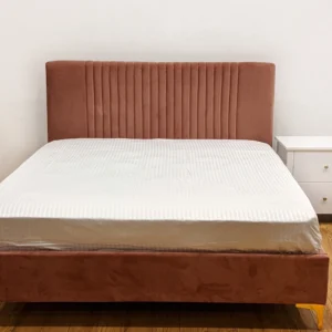 Monsoon Amberhaven 5×6 dusty rose upholstered bed with tall vertical channel headboard, matching footboard and gold-tone legs