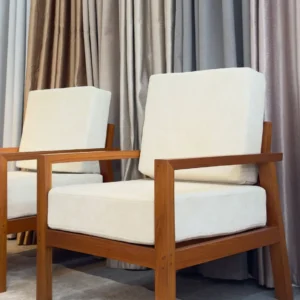 Cream upholstered lounge chair with brown Mkongo hardwood frame and straight wooden armrests