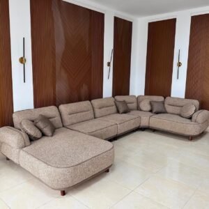 Monsoon Baycrest beige U-shape sectional sofa with double chaise ends, segmented back cushions and short brown legs.