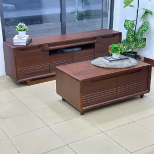 Monsoon Bayhaven warm brown TV stand and matching rectangular coffee table with recessed handles and horizontal grooved fronts.
