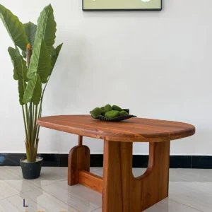 Reddish-brown L coffee table with rounded rectangular top and U-shaped cut-out wooden-look pedestal