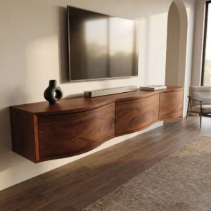 floating TV stand with a curved wood-grain front, three handle-free-looking cabinet panels and rounded right end beneath a wall-mounted television.