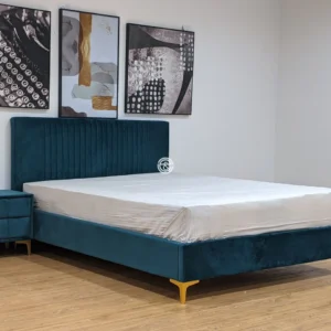 Monsoon Bellland 5×6 deep teal upholstered bed with vertical-channel headboard, matching padded frame and gold-tone legs.