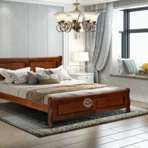 Monsoon Brookmere 5×6 brown wooden bed with two-panel recessed headboard, matching raised footboard and curved upper rails.
